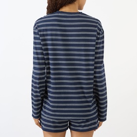 Model wearing Sporty and Rich dark navy and white striped long-sleeve T-shirt, shown from the back, styled with matching shorts.