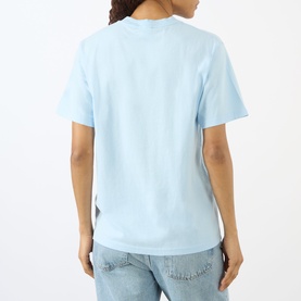 Model wearing Sporty and Rich Ciel blue T-shirt, back view, styled with light wash denim jeans.