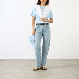 Model wearing Sporty and Rich Ciel T-shirt with white collar detail, styled with light wash straight jeans, belt, and sandals.