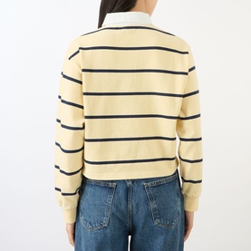Model wearing Sporty and Rich almond navy striped cotton polo top, cropped fit, back view, styled with blue jeans