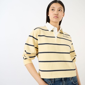 Model wearing Sporty and Rich almond and navy striped cotton rugby polo top with white collar, cropped fit