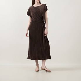 Model wearing Vince Diagonal Pleated Twist Dress in brown, midi length with cap sleeves and twist waist detail, styled with gold strappy sandals.