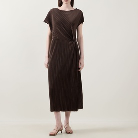 Model wearing Vince Diagonal Pleated Twist Dress in brown, featuring cap sleeves, midi length and twist waist detail, styled with strappy flat