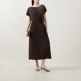 Model wearing Vince Diagonal Pleated Twist Dress in brown, featuring cap sleeves, twist waist detail and midi length, styled with nude sandals.