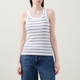 Model wearing Vince Stripe Ribbed Tank Top in white with grey stripes, scoop neckline, racer-style back, styled with blue jeans.