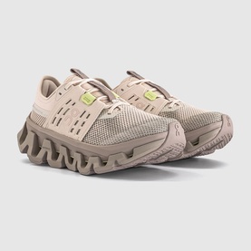 On Running trainers in sand desert, mesh upper with wave-patterned chunky sole, lime green heel tab detail, pair shown together