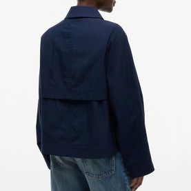 Model wearing Tommy Hilfiger Dark Night Navy cropped jacket, back view, styled with light-wash jeans