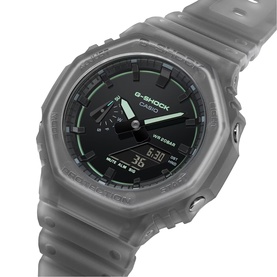 Casio G-Shock grey semi-transparent resin watch with octagonal case, black dial, green accents, and digital-analogue display