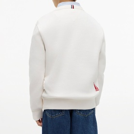 Model wearing white crew neck sweatshirt, back view showing red and blue striped collar detail, styled with blue jeans
