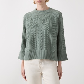 Model wearing Elena Miro flint cable-knit wool sweater with crew neck and wide sleeves, styled with cream wide-leg trousers.