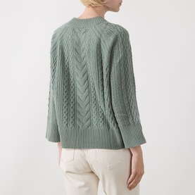 Model wearing Elena Miro flint cable-knit wool sweater, back view, with cream trousers
