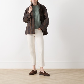 Model wearing Elena Miro flint green knit jumper, styled with brown check jacket, white cropped trousers and brown loafers.