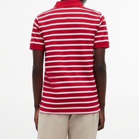 Model wearing red and white striped short-sleeve polo shirt, back view, styled with beige trousers