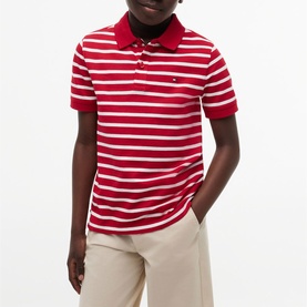 Model wearing red and white striped short-sleeve polo shirt with red collar, styled with beige trousers