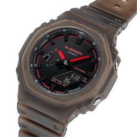 Casio G-Shock watch in brown translucent resin case and strap with black dial and red accents, analogue-digital display