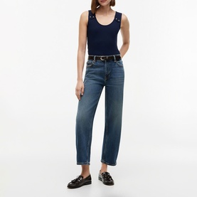 Model wearing Tommy Hilfiger Dark Night Navy sleeveless top with scoop neck, styled with mid-blue straight-leg jeans and black loafers.