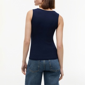 Model wearing Tommy Hilfiger Dark Night Navy sleeveless ribbed knit top, back view, styled with light wash jeans.