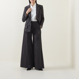 Model wearing HIGH Shimmy Layered Pinstripe Blazer in grey, single-breasted with notch lapel, styled with wide-leg pinstripe trousers and white shirt.