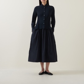 Model wearing HIGH Habit Shirt Dress in navy, midi length with raised shirt hem, crinkled skirt, button front, styled with black ballet flats
