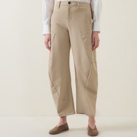 Model wearing HIGH Greece Barrell Leg Boyfriend Fit Trousers in beige, styled with brown loafers. Wide-leg silhouette with seam detailing.