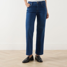 Model wearing Mother straight-leg jeans in Pinkies Up mid-blue denim, styled with black leather loafers, cropped ankle length