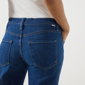 Model wearing Mother Straight Jeans in Pinkies Up mid-blue denim, close-up of back pockets and fit detail, styled with white top