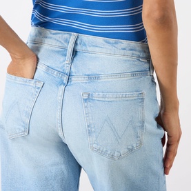 Model wearing Mother The Dodger Ankle Straight Jeans in Fringe Benefits light wash, showing back detail with logo branding and five-pocket styling.