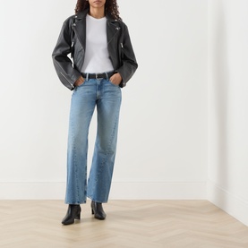 Model wearing Mother Wide Leg jeans in Leap At The Chance, styled with a grey leather biker jacket, white tee and black ankle boots.