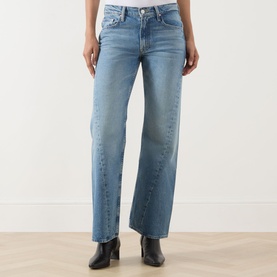 Model wearing Mother Wide Leg Jeans in Leap At The Chance light blue wash, paired with black ankle boots.