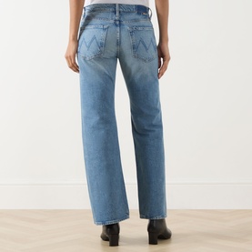 Model wearing Mother Wide Leg Jeans in Leap At The Chance blue denim, rear view, styled with black ankle boots.