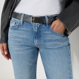 Model wearing Mother Wide Leg jeans in Leap At The Chance light blue denim, styled with a black leather jacket and black leather belt.