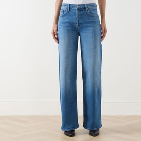 Model wearing Mother Wide Leg jeans in Kissing The Caddy blue denim, high-rise waist, relaxed wide-leg fit, styled with black shoes.