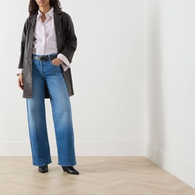 Model wearing Mother Wide Leg jeans in Kissing The Caddy, styled with a dark blazer, white shirt and black heeled mules.