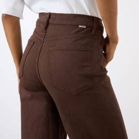 Model wearing Mother Decadent Chocolate wide leg jeans, rear view showing back pockets and high waist in 100% cotton denim