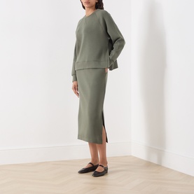 Model wearing Part Two Beetle sweat top with matching khaki midi skirt and black flat shoes.