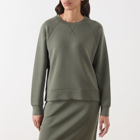 Model wearing Part Two Beetle sweatshirt with raglan sleeves, styled with matching midi skirt in the same khaki-green hue.