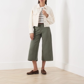 Model wearing Part Two Beetle Stripe cotton T-shirt, styled with cream jacket, khaki wide-leg culottes and brown loafers.