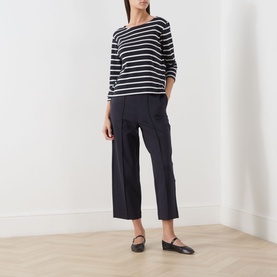 Model wearing Part Two Navy/Eggnog Stripe cotton top with three-quarter sleeves, styled with navy wide-leg cropped trousers and black flat shoes.