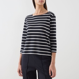 Model wearing Part Two navy and eggnog stripe cotton top with three-quarter sleeves and boat neckline, styled with navy trousers.