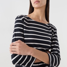 Model wearing Part Two Top in Navy and Eggnog Stripe, cropped view showing boat neckline and three-quarter length sleeves, arms crossed.