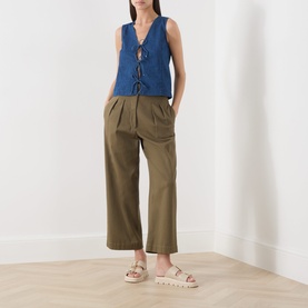 Model wearing Part Two medium dark blue cotton lace-front vest top with khaki wide-leg trousers and cream flatform sandals.