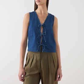 Model wearing Part Two medium dark blue cotton sleeveless top with V-neck and tie-front bow detail, styled with khaki wide-leg trousers.