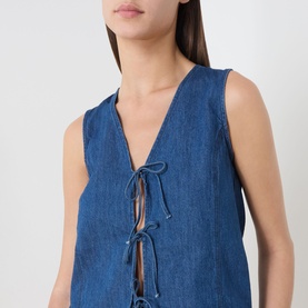 Model wearing Part Two medium dark blue sleeveless denim top with V-neck and lace-up front tie detail.