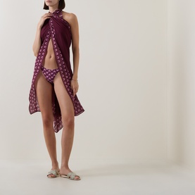 Model wearing Seafolly Dark Burgundy Bikini Brief, styled with a matching burgundy printed sarong and silver flat sandals.