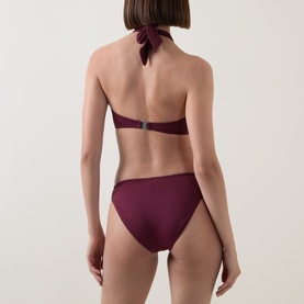 Model wearing Seafolly Dark Burgundy Bikini Brief, shown from behind, paired with matching halterneck bikini top.