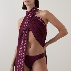 Model wearing Seafolly Dark Burgundy Bikini Brief styled with matching halterneck wrap top featuring floral trim detail.