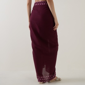 Model wearing Seafolly Dark Burgundy cotton sarong, shown from behind, featuring embroidered trim detail at waist and hem