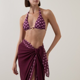 Model wearing Seafolly Dark Burgundy bikini top with floral print and gold ring detail, styled with matching sarong skirt.