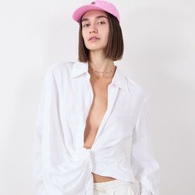 Model with Seafolly Logo Washed Baseball Cap in Pop Pink, six-panel cotton design with contrast embroidered logo, styled with white open shirt and