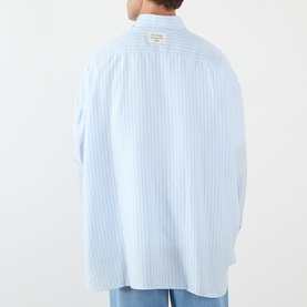 Model wearing Acne Stripe Logo Shirt in blue, rear view showing relaxed fit, vertical stripes, and logo label at back collar.